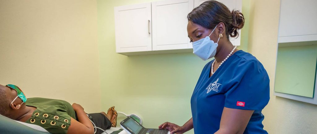 Dr. Bowen using ECG machine